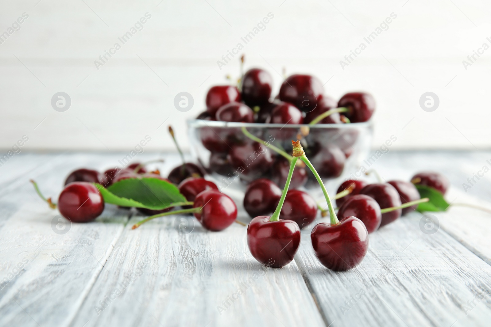 Photo of Sweet red cherries on wooden table