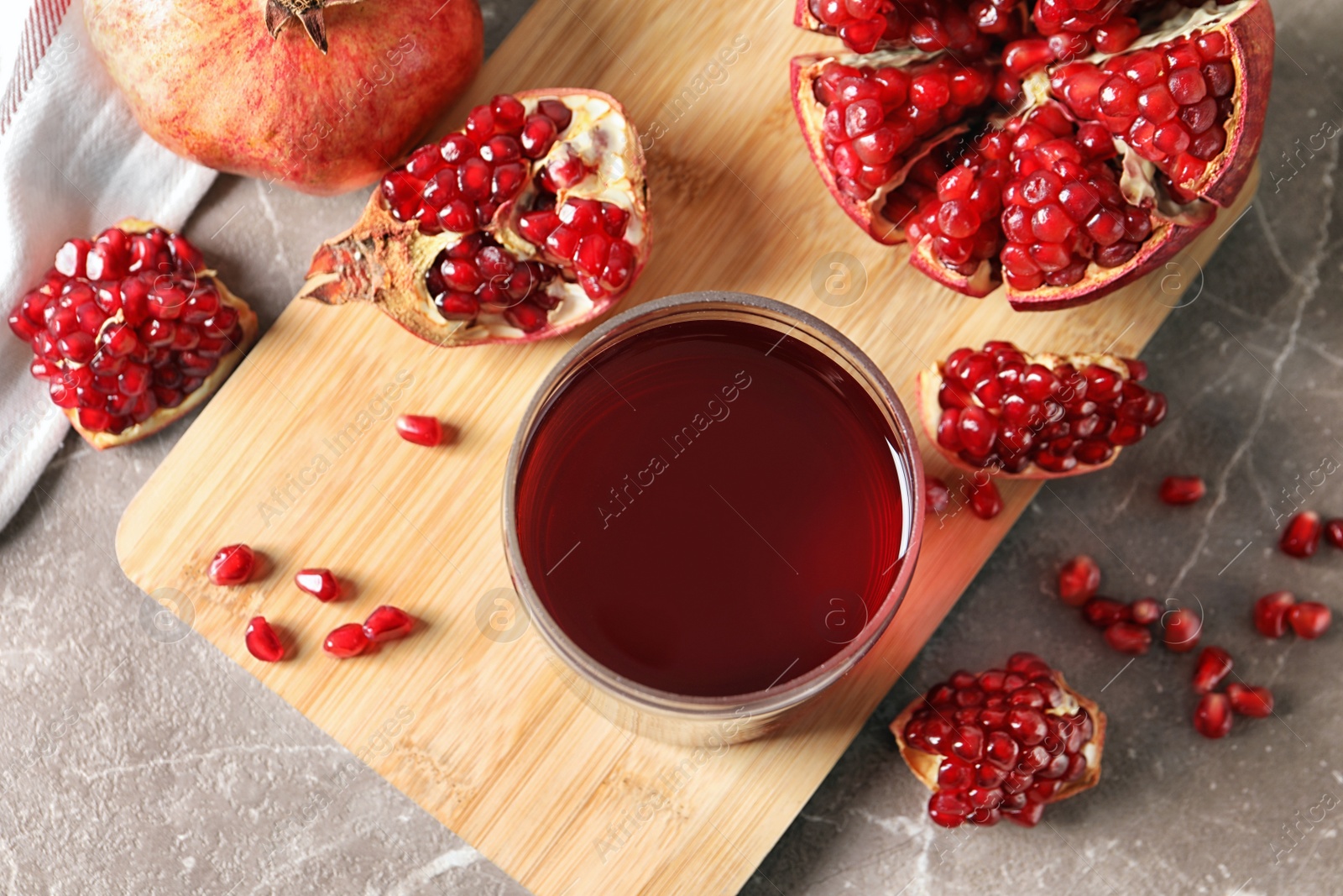 Photo of Flat lay composition with pomegranate juice, fruit and seeds on table