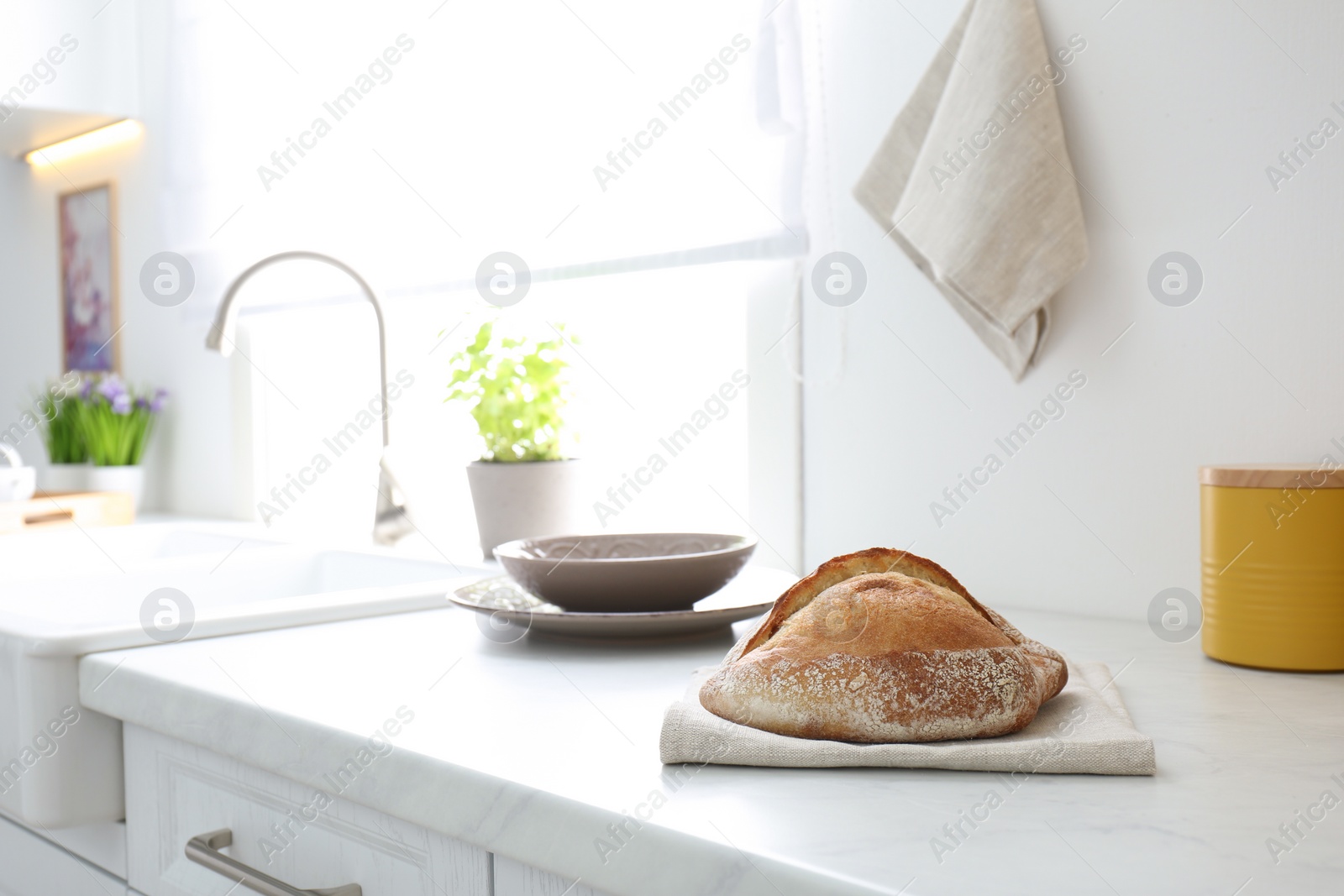 Photo of Fresh bread on countertop in modern kitchen. Space for text