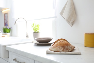 Fresh bread on countertop in modern kitchen. Space for text