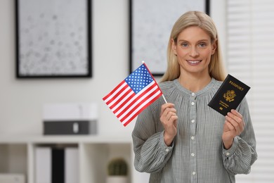 Immigration. Happy woman with passport and American flag indoors, space for text