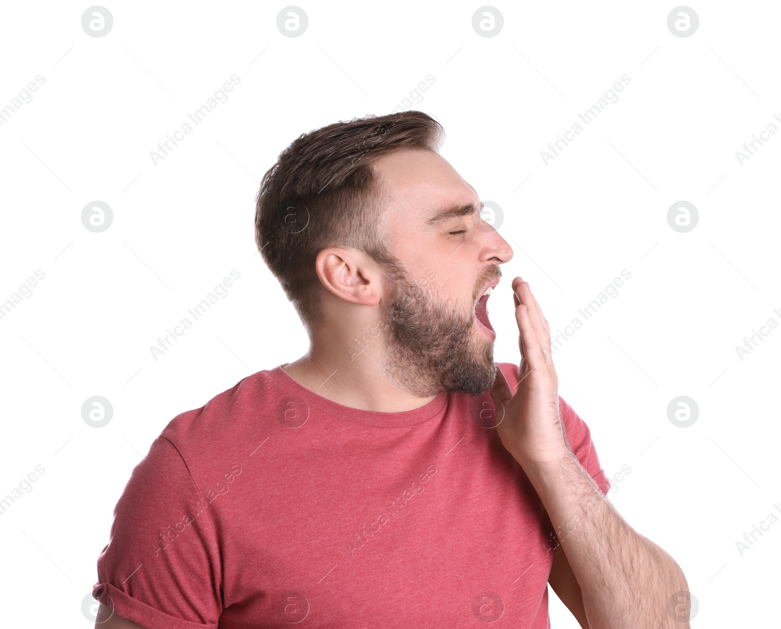 Photo of Sleepy young man yawning on white background