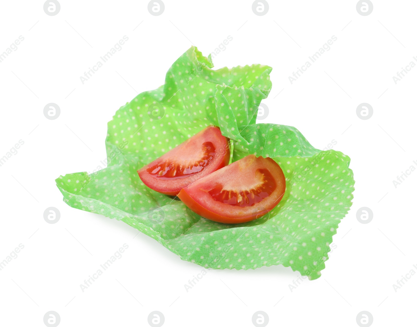 Photo of Slices of fresh tomato in beeswax food wrap isolated on white