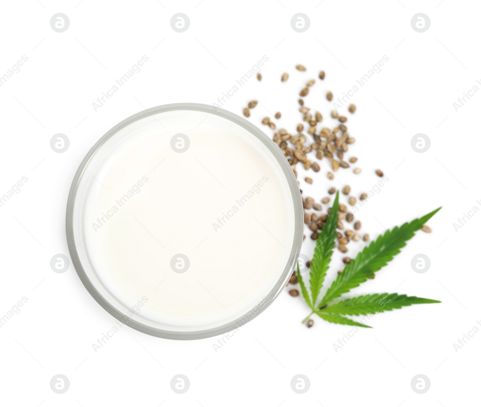 Photo of Glass of fresh hemp milk, seeds and leaf on white background, top view