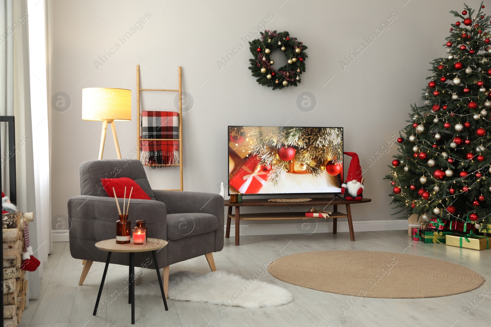 Photo of Stylish living room interior with modern TV and Christmas tree