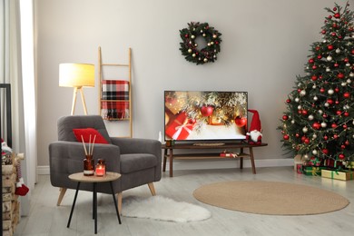 Photo of Stylish living room interior with modern TV and Christmas tree