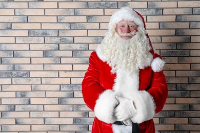 Photo of Authentic Santa Claus on brick wall background