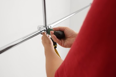 Worker installing new metal pipes with electric drill, closeup