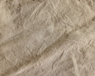 Photo of Beautiful beige fabric as background, top view