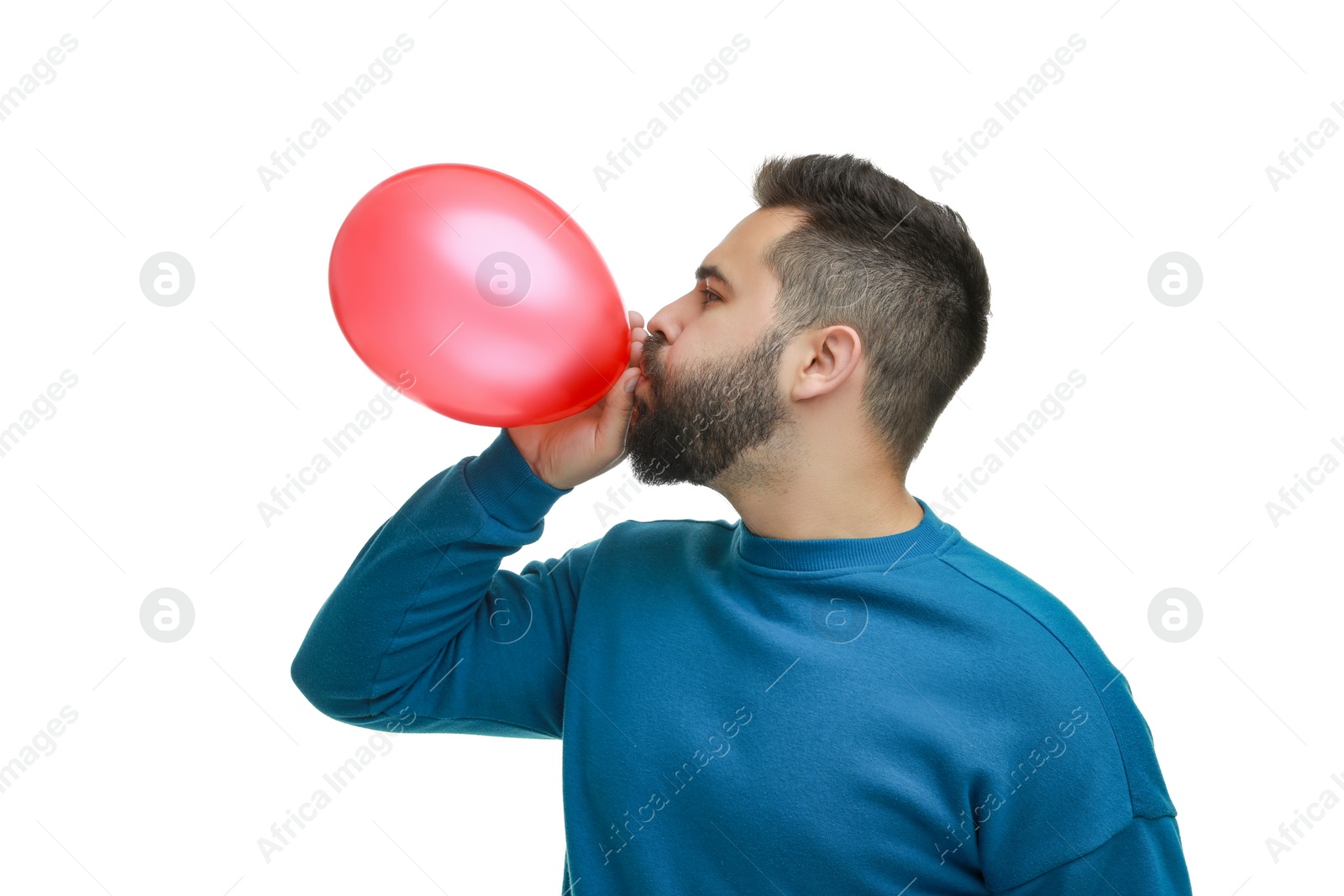 Photo of Man inflating bright balloon on white background