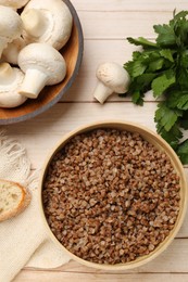 Photo of Tasty buckwheat in bowl on wooden table, flat lay