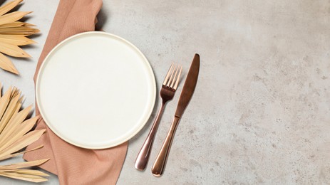 Photo of Setting with beautiful cutlery on textured table, top view. Space for text