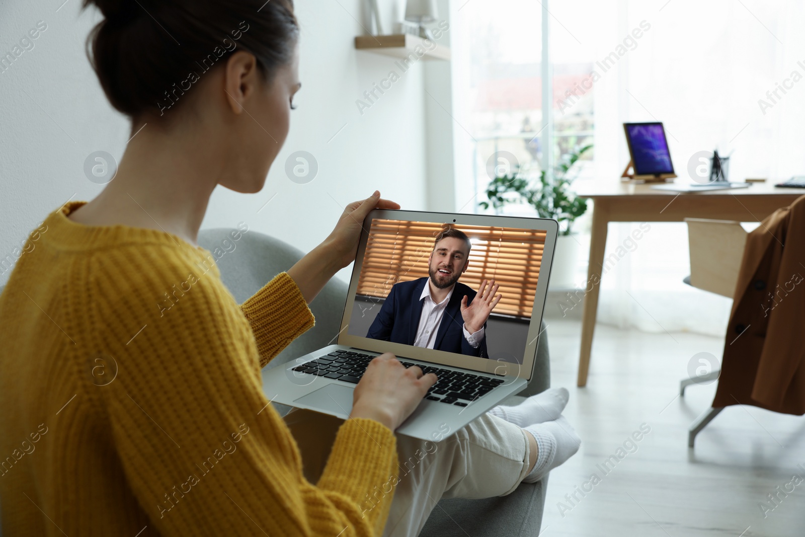 Image of Woman talking with handsome man using video chat on laptop indoors, closeup. Online dating