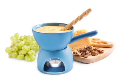 Composition with pot of delicious cheese fondue on white background