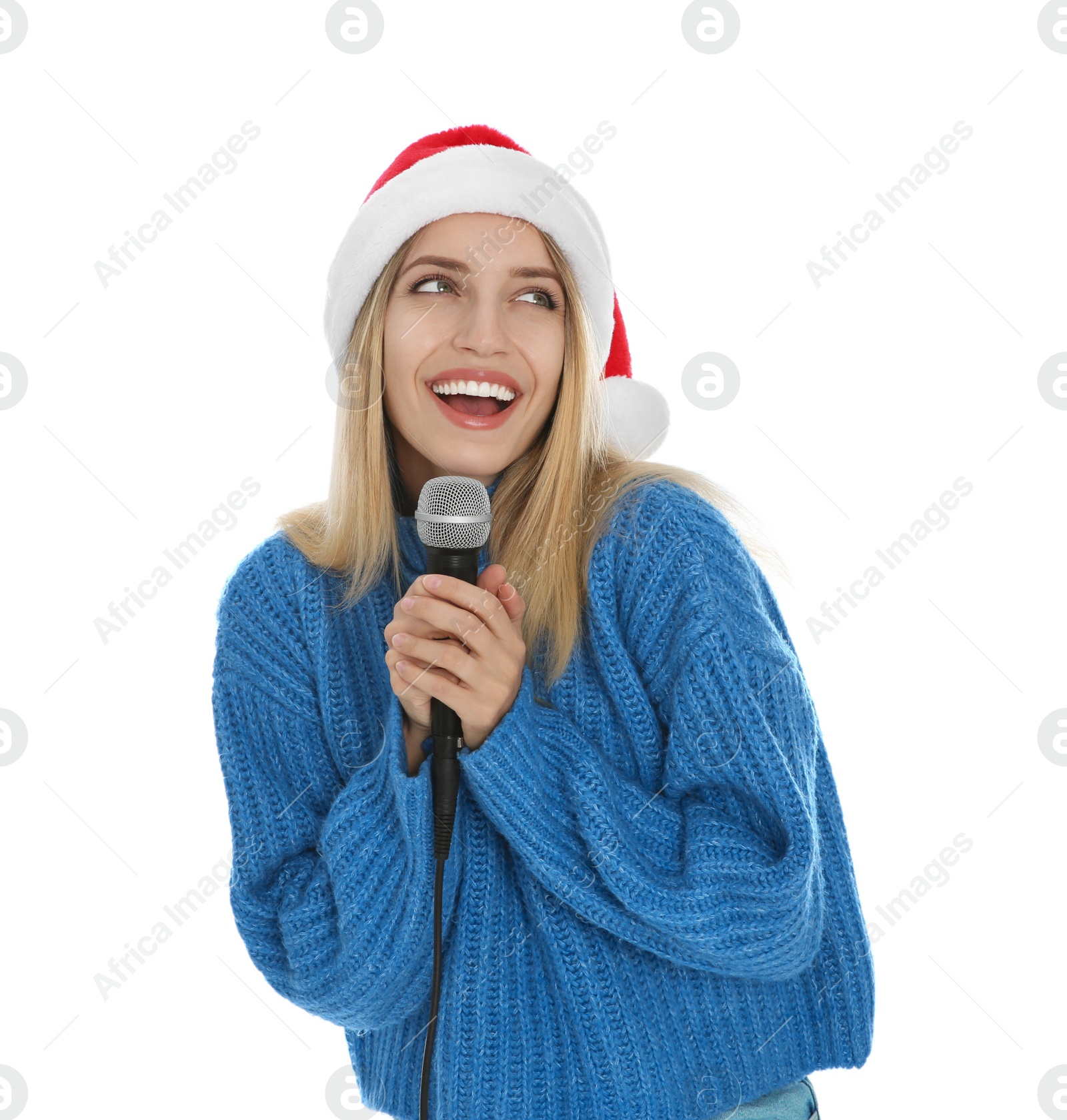 Photo of Happy woman in Santa Claus hat singing with microphone on white background. Christmas music