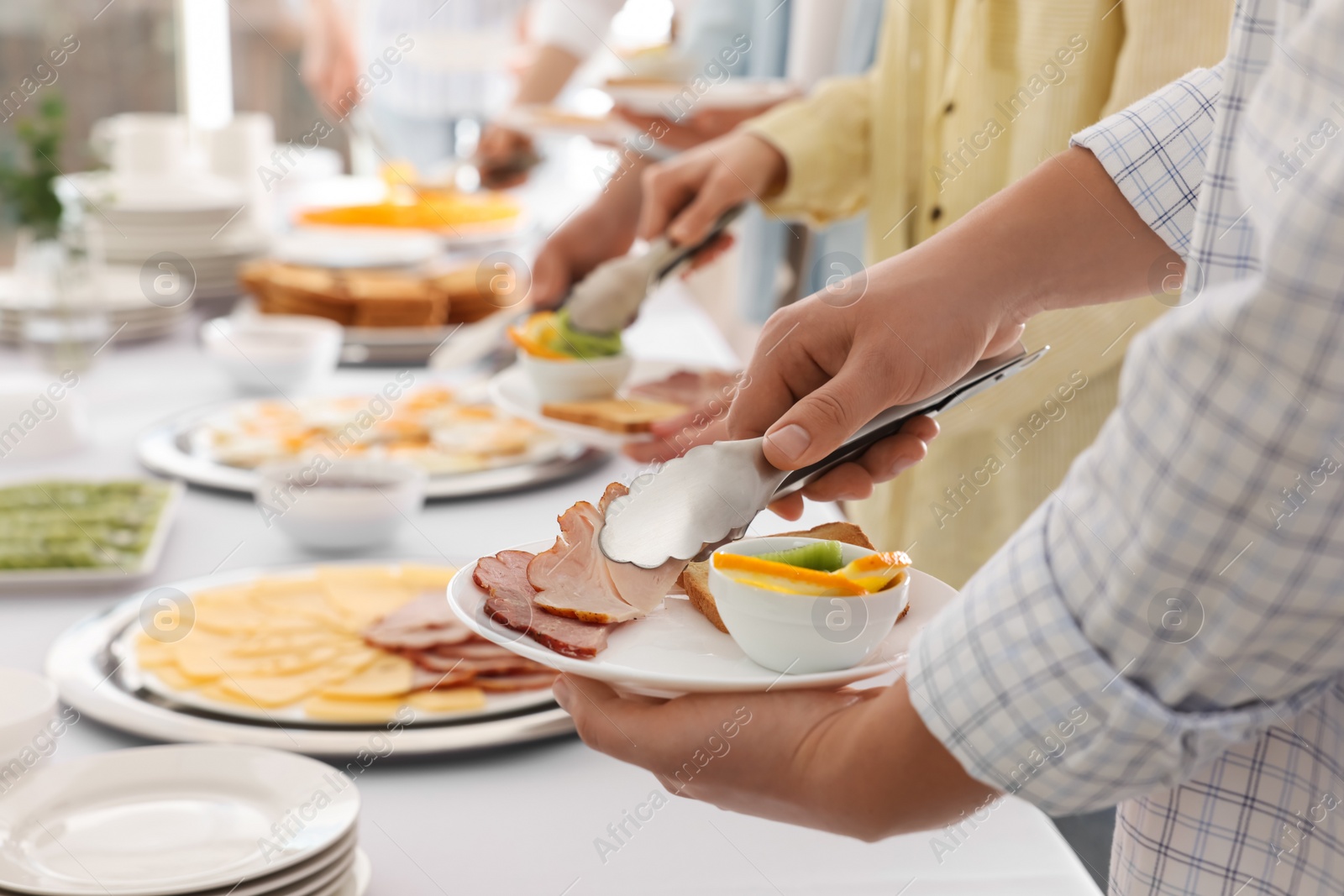 Photo of People taking food during breakfast, closeup. Buffet service