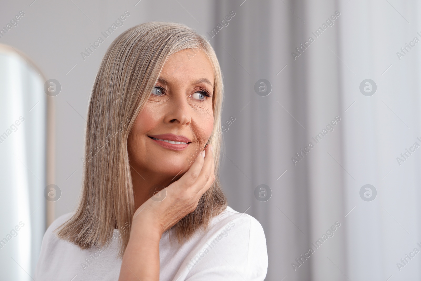 Photo of Portrait of beautiful middle aged woman indoors. Space for text