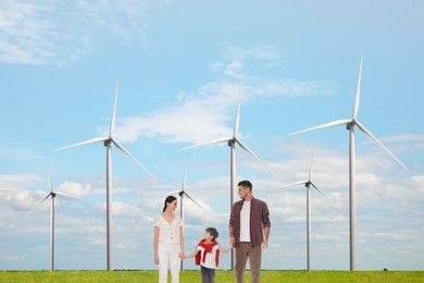 Image of Happy family with child and view of wind energy turbines