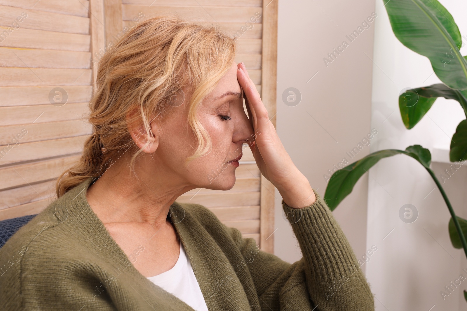 Photo of Upset middle aged woman sulking at home. Loneliness concept