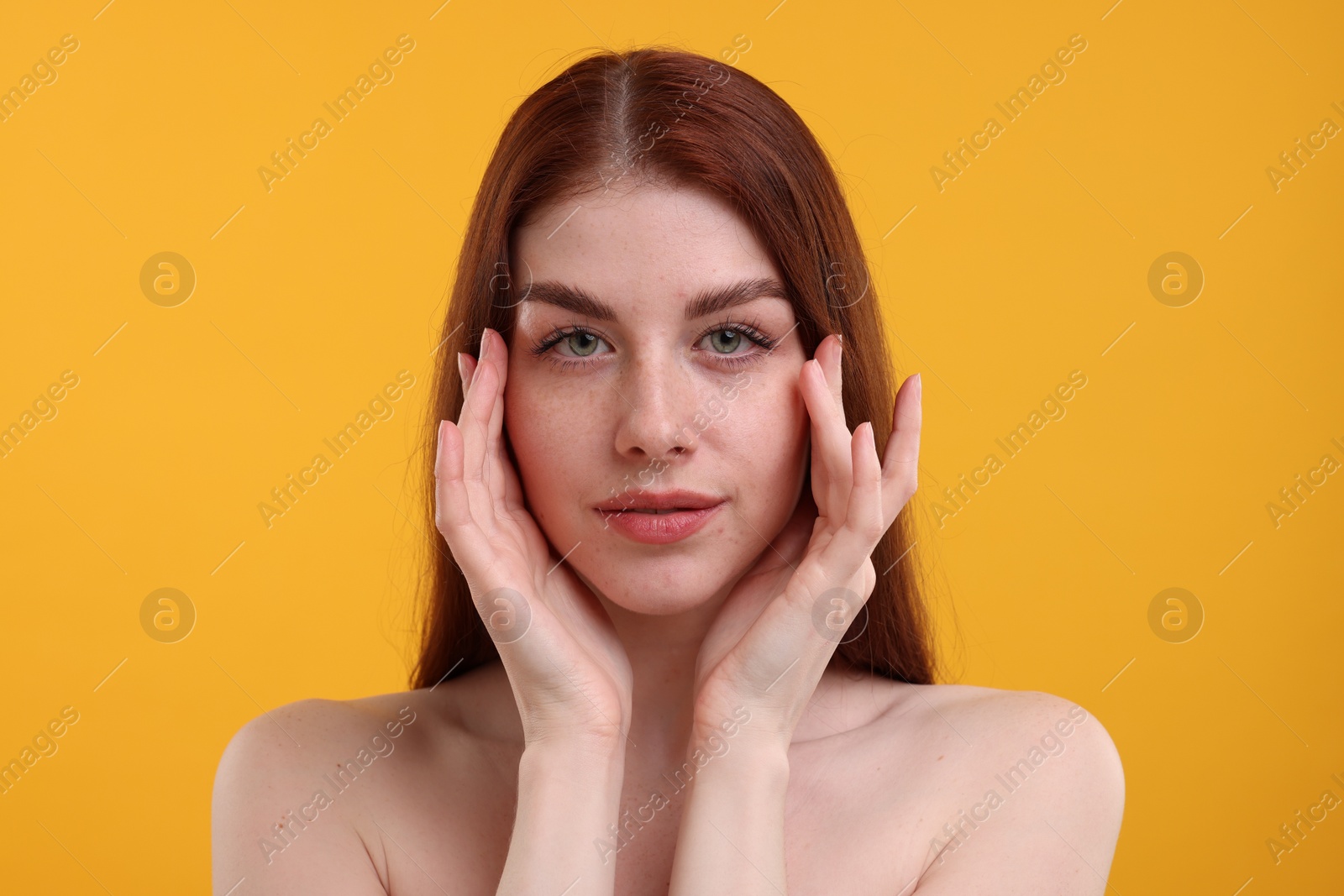 Photo of Portrait of beautiful woman with freckles on yellow background