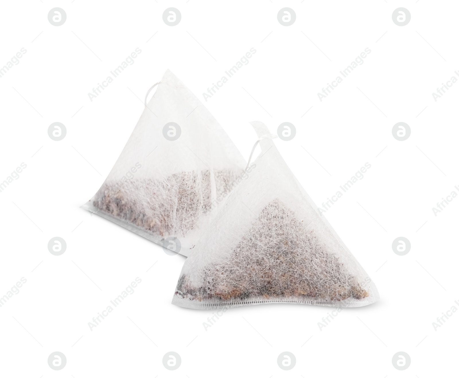 Photo of New pyramid tea bags on white background