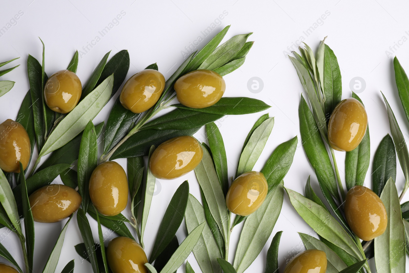 Photo of Twigs with olives and fresh green leaves on white background, flat lay