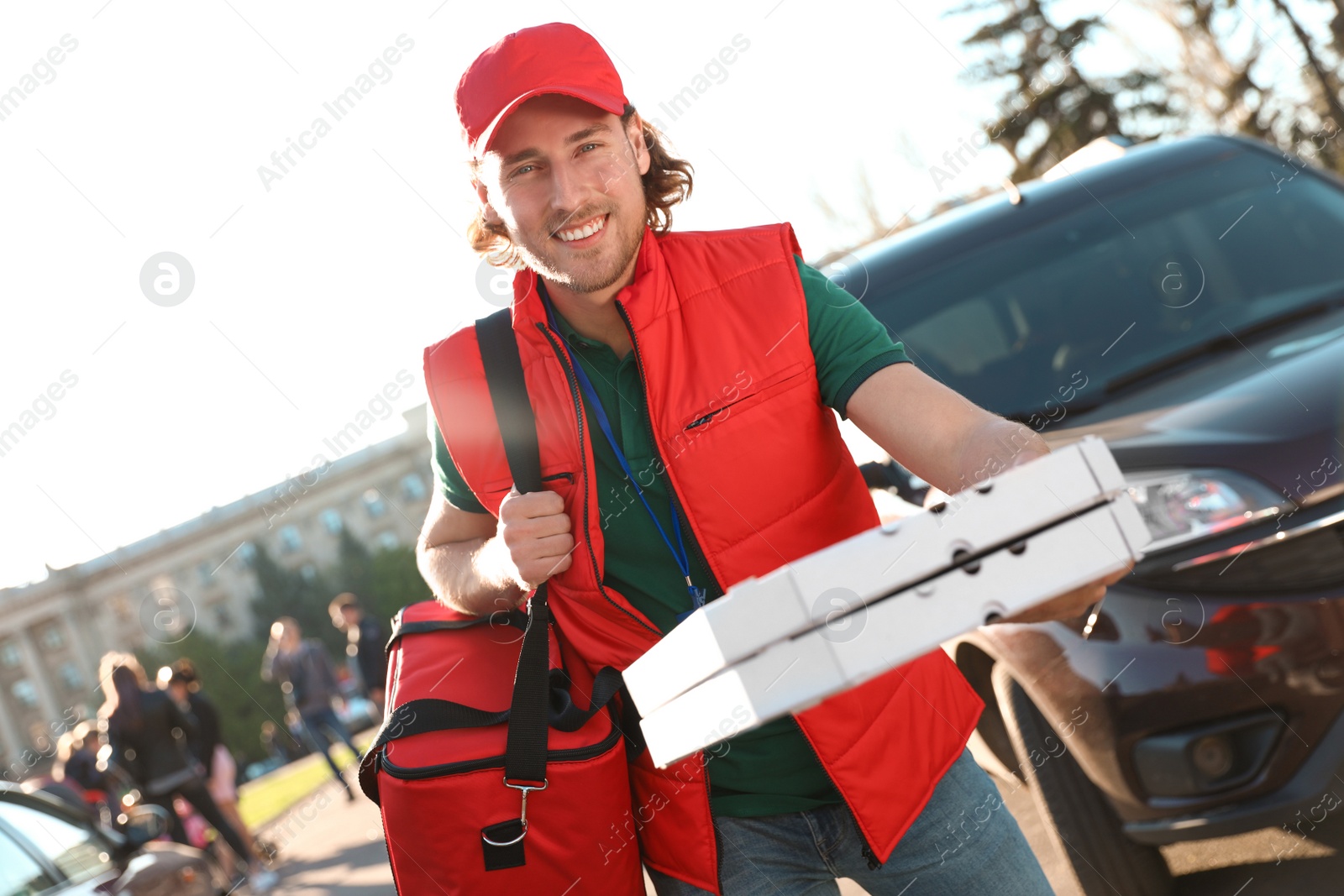 Photo of Male courier delivering food in city on sunny day