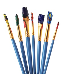 Photo of Different brushes with paints on white background