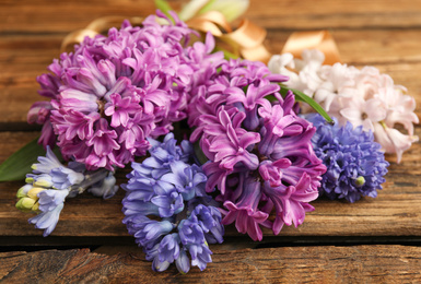 Beautiful spring hyacinth flowers on wooden table, closeup
