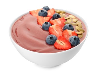 Photo of Bowl of delicious smoothie with fresh blueberries, strawberries and pumpkin seeds on white background