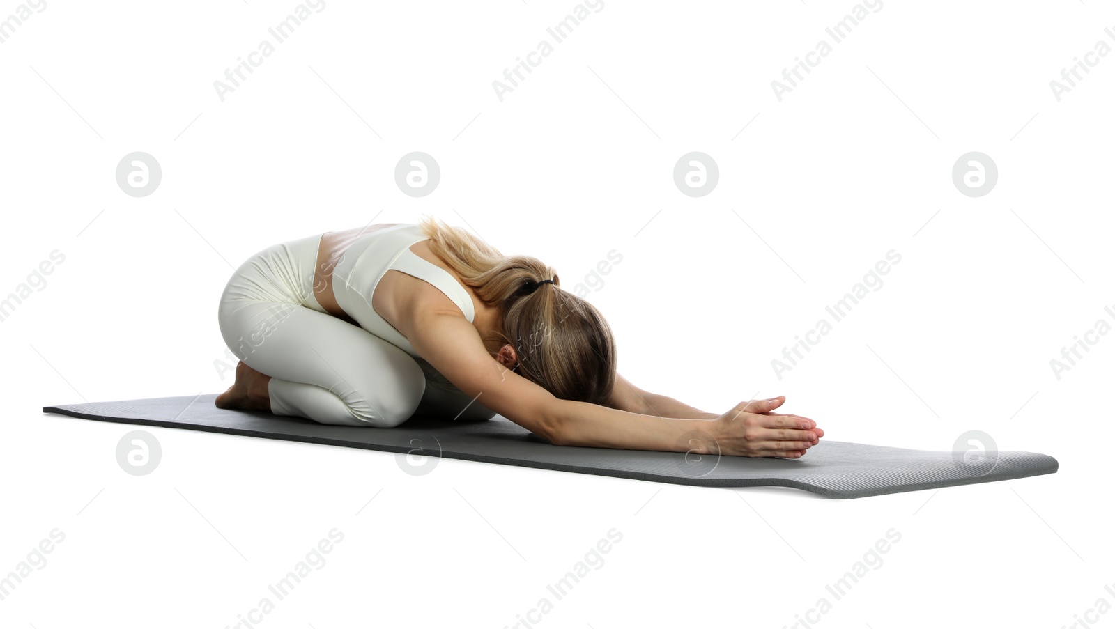 Photo of Young woman in sportswear practicing yoga on white background