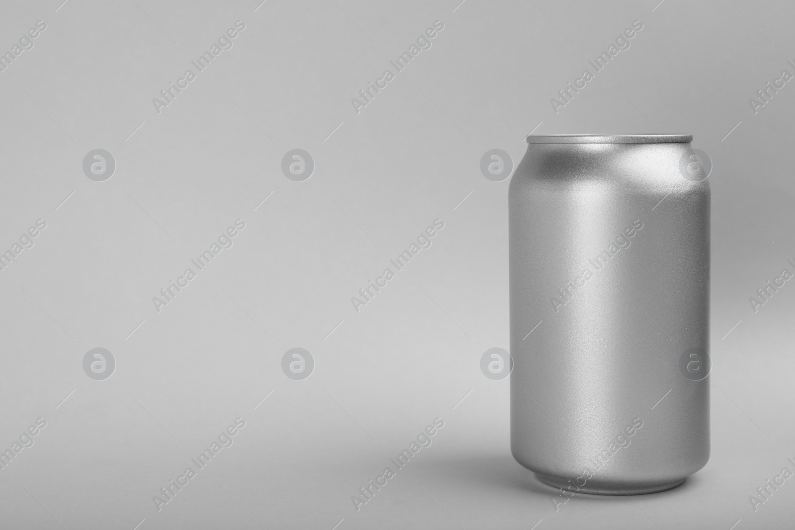 Photo of Can of energy drink on light grey background. Space for text