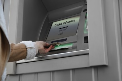 Image of Woman using cash machine for money withdrawal outdoors, closeup