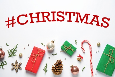 Image of Hashtag Christmas, gift boxes and festive decor on white background, flat lay