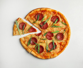 Tasty pepperoni pizza with arugula on white table, flat lay