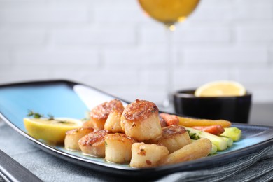 Photo of Delicious fried scallops with asparagus served on table, closeup