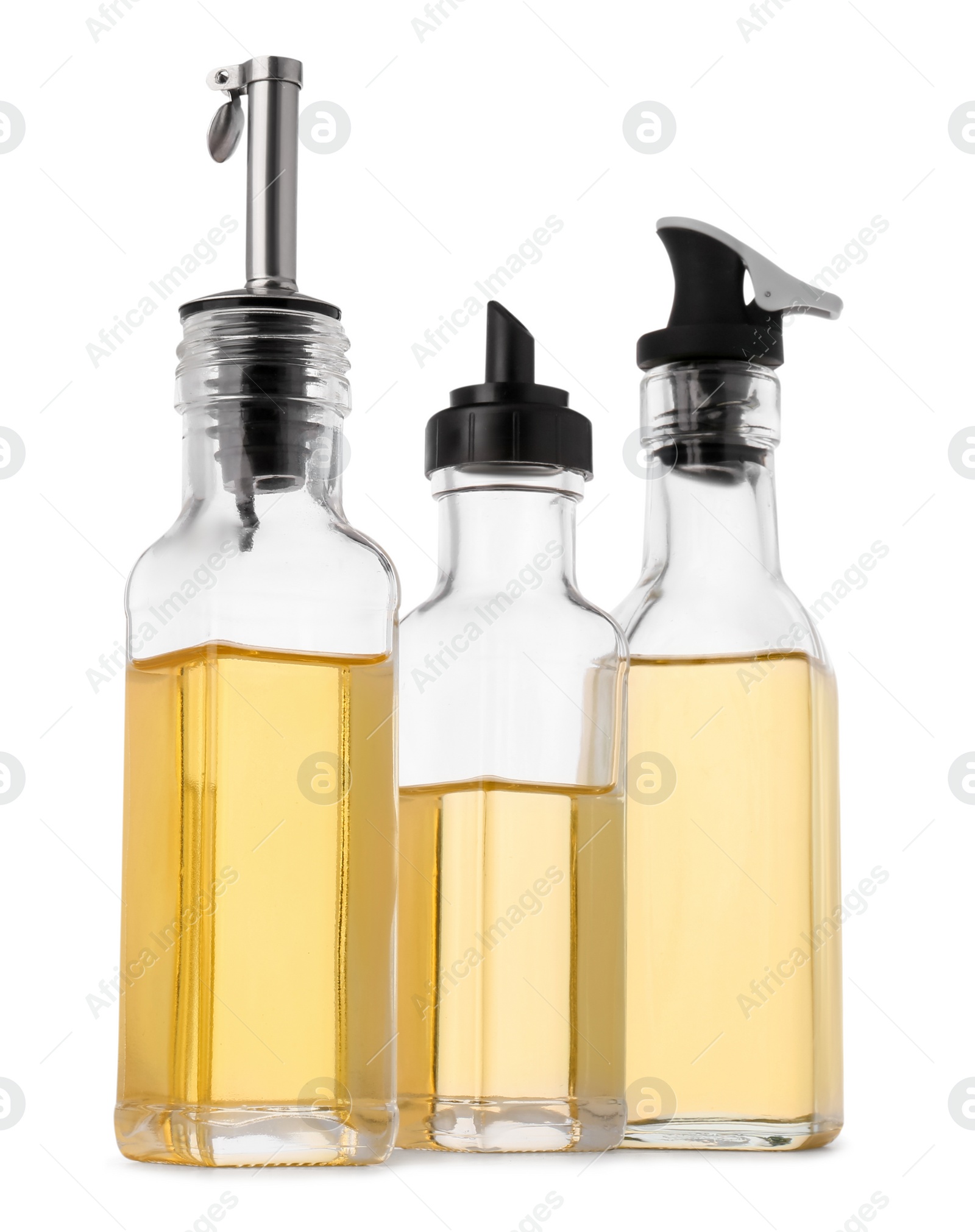 Photo of Glass bottles of cooking oil on white background