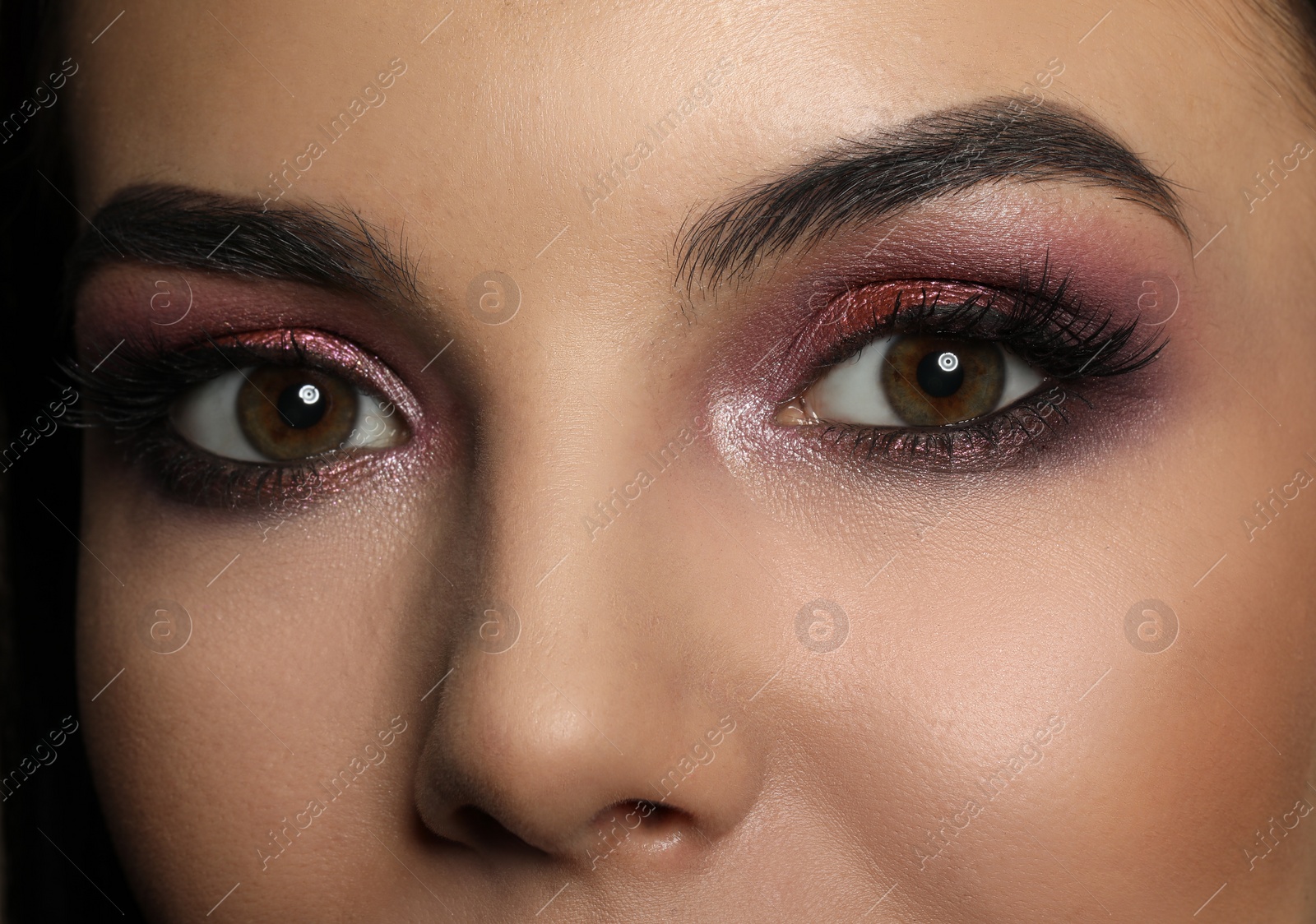 Photo of Young woman with evening makeup, closeup. Eye shadow product