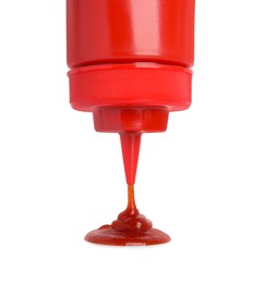 Pouring tasty red ketchup from bottle isolated on white