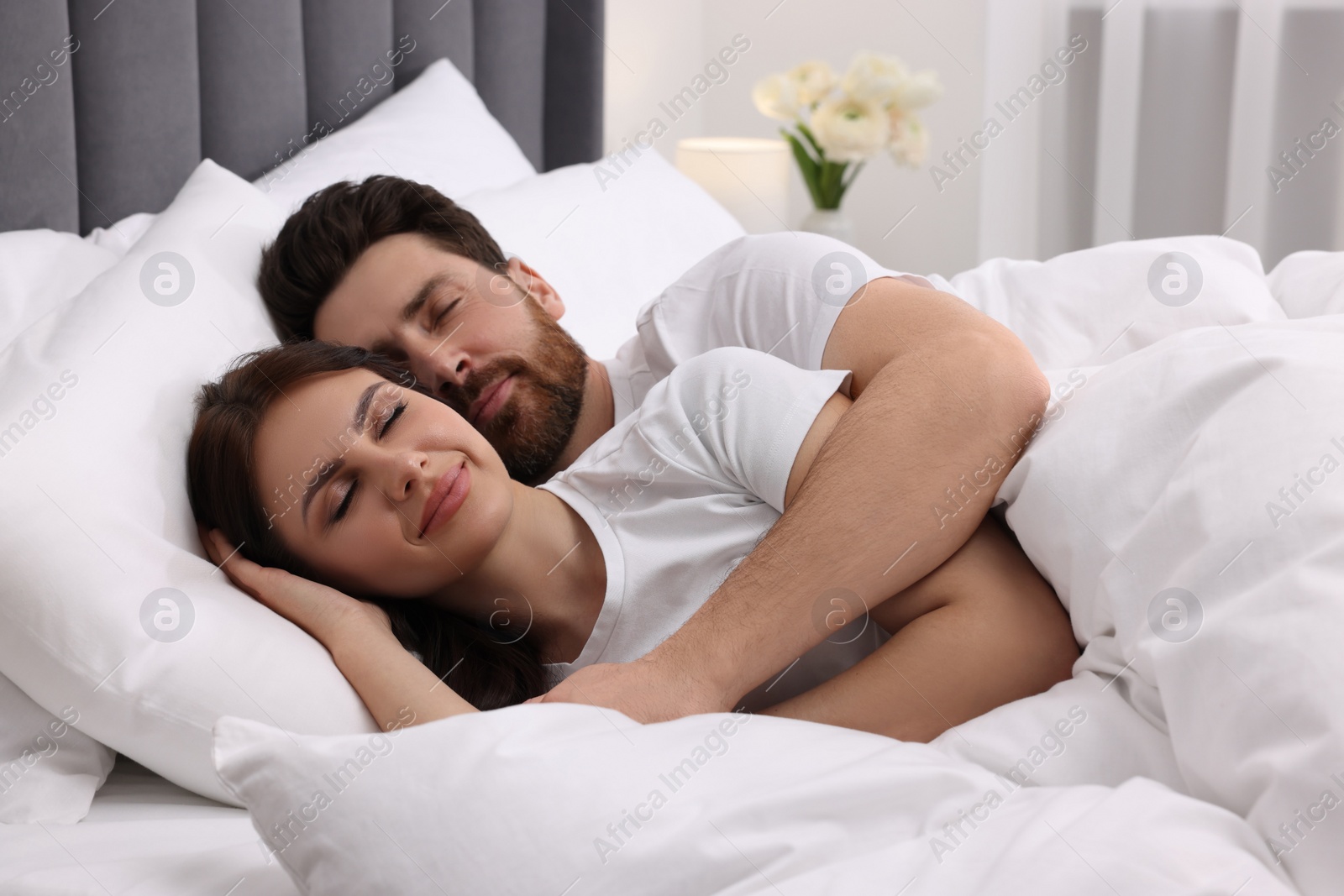 Photo of Lovely couple sleeping together in bed at home