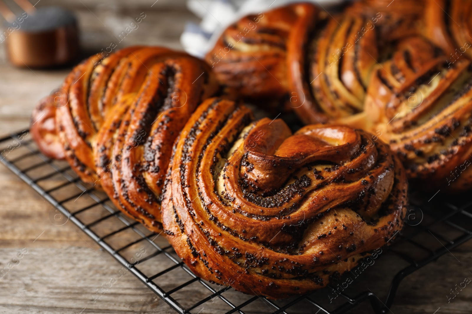 Photo of Tasty sweet buns with poppy seeds on wooden table