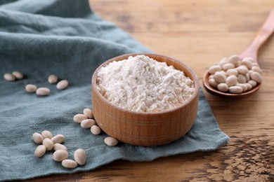 Kidney bean flour and seeds on wooden table, closeup