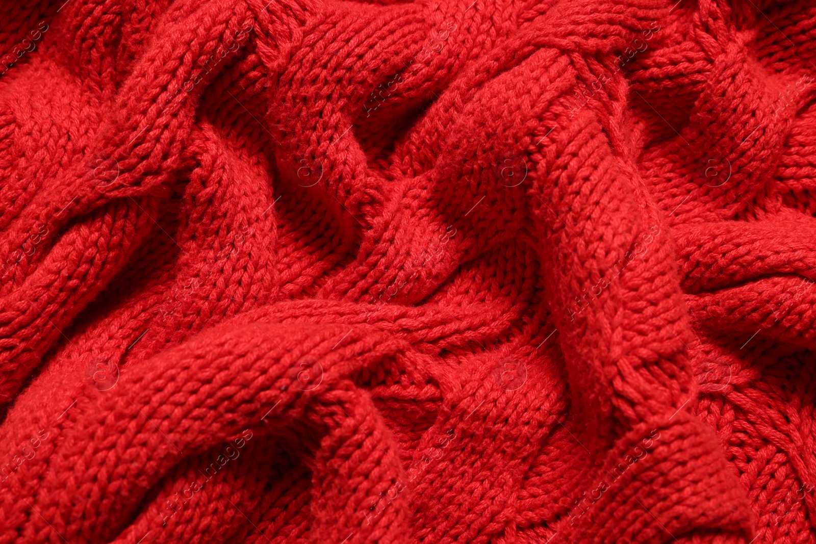 Photo of Texture of soft red knitted fabric as background, top view