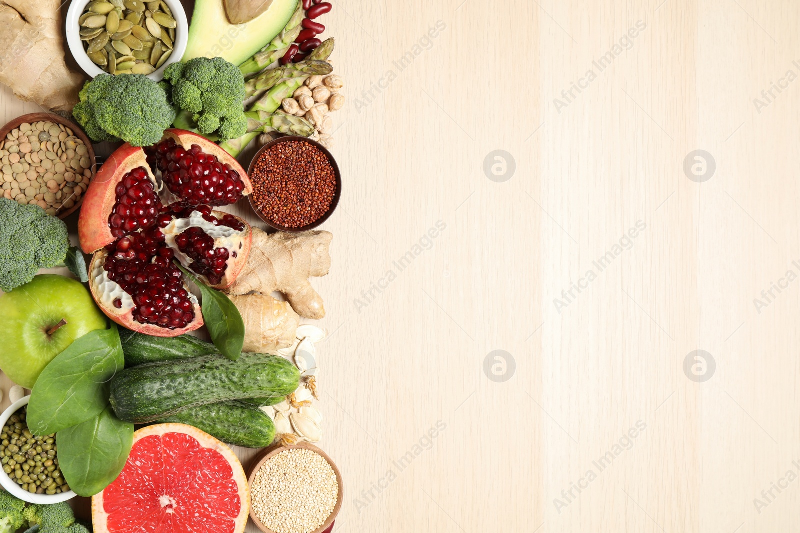 Photo of Fresh vegetables, fruits and seeds on light table, flat lay. Space for text.