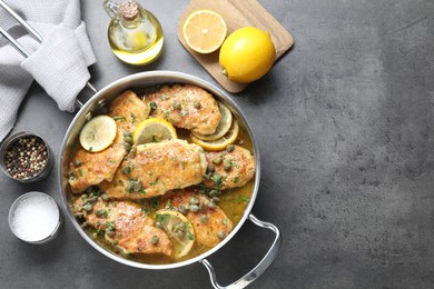 Delicious chicken piccata on grey table, flat lay. Space for text