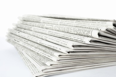Photo of Stack of newspapers on white background. Journalist's work