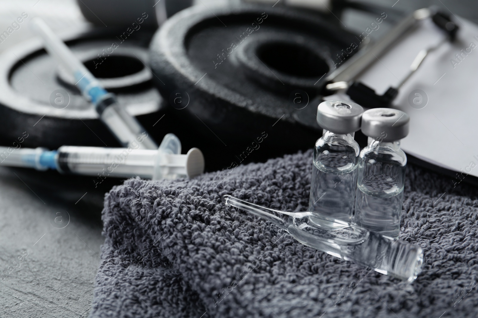 Photo of Different drugs and sports equipment on table, closeup. Doping control