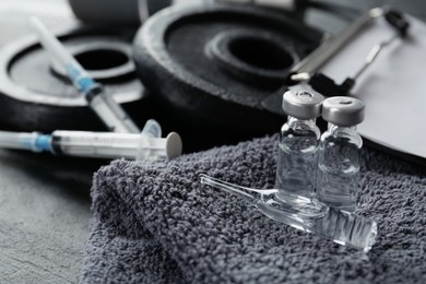 Different drugs and sports equipment on table, closeup. Doping control