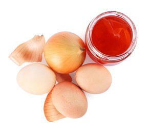 Easter eggs painted with natural dye and onion on white background, top view