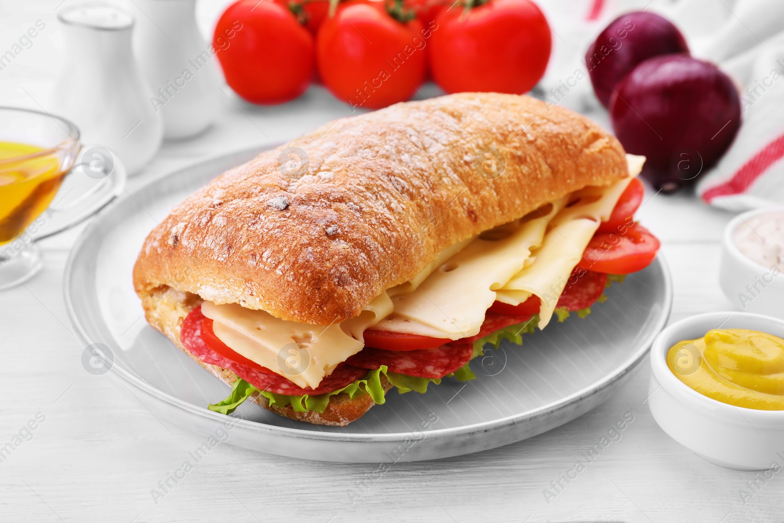 Photo of Delicious sandwich with cheese, salami, tomato on white wooden table, closeup